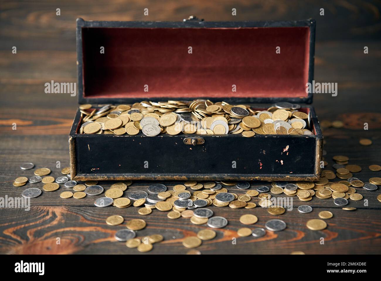 An overflowing treasure chest filled with gold coins -- antique