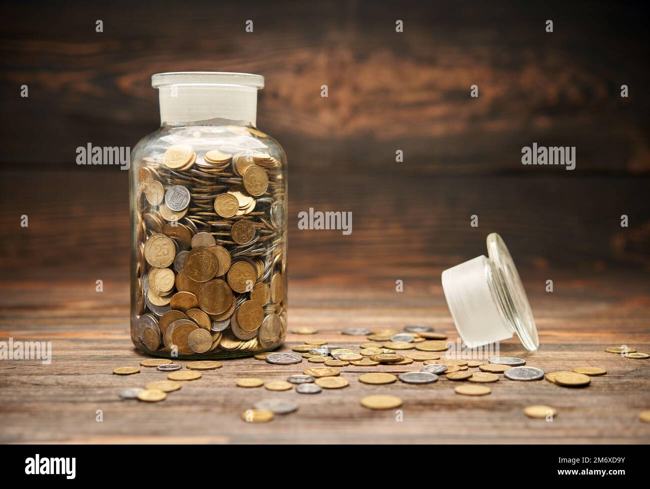 Glass jar filled of golden coins Stock Photo