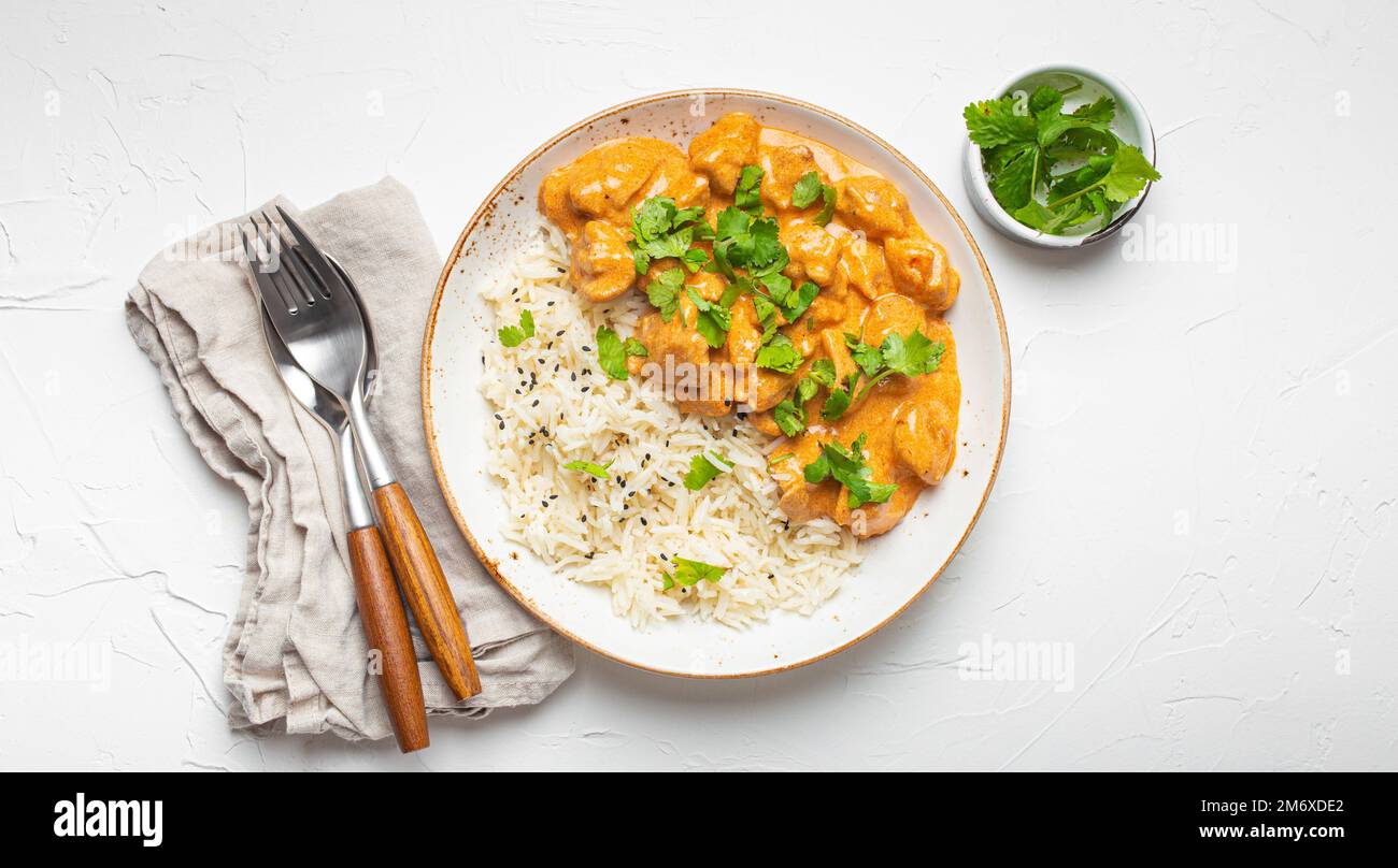 Traditional Indian dish chicken curry with basmati rice and fresh