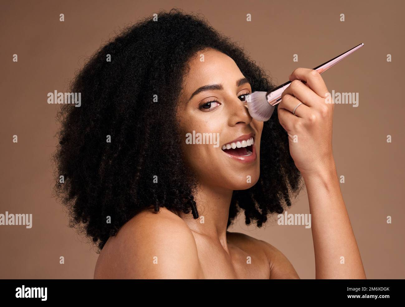 Black woman, studio portrait and makeup brush for foundation, beauty ...