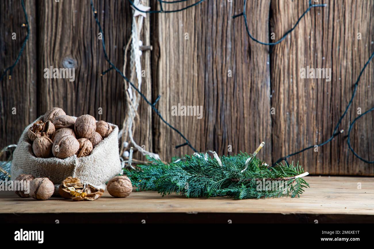 Festive christmas nuts tumbling from a burlap bag Stock Photo
