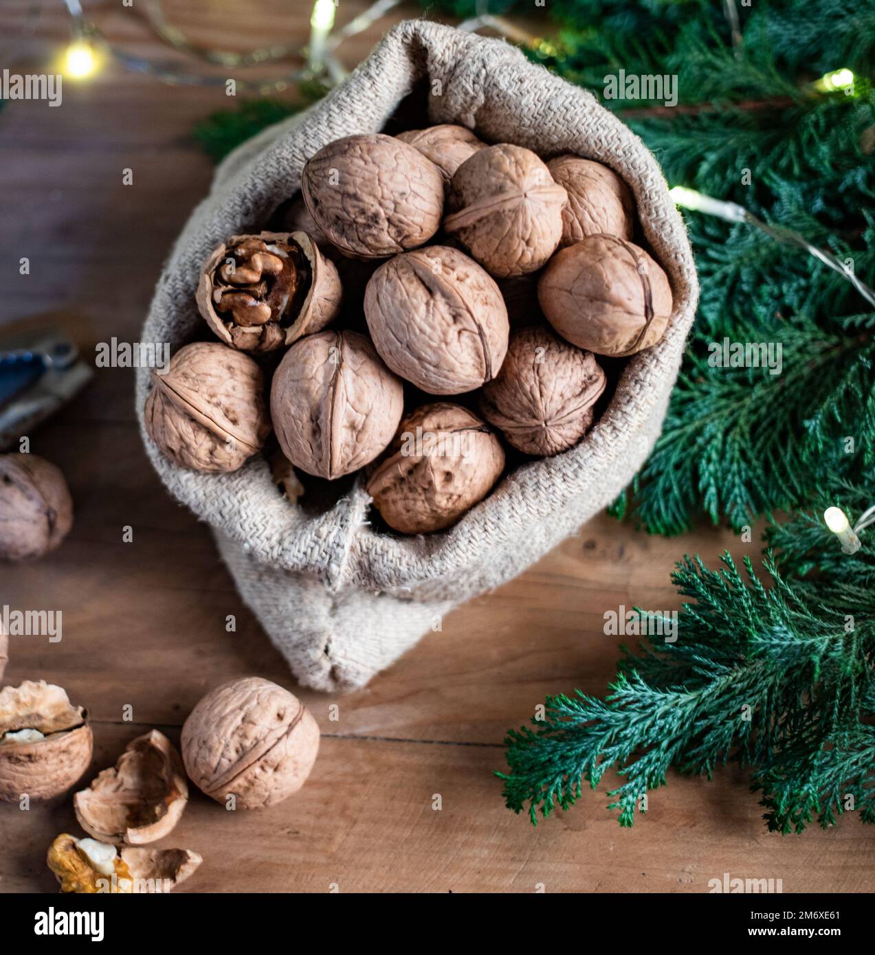 Festive christmas nuts tumbling from a burlap bag Stock Photo