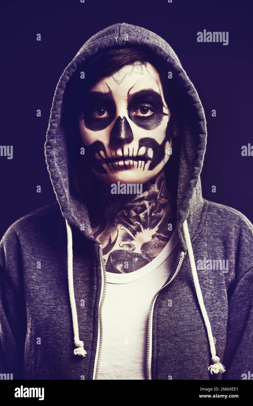 Living dead. A woman with a traditional calaveras death mask painted on