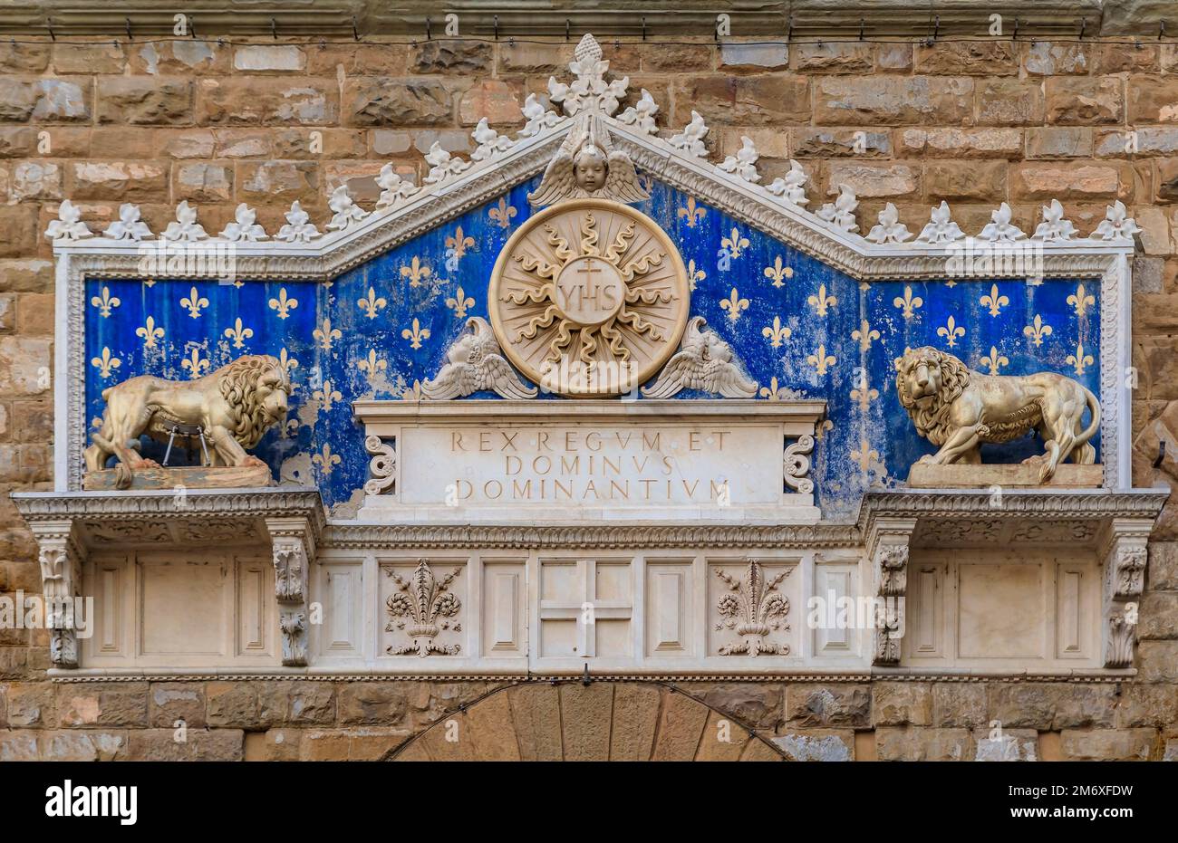 Florence, Italy - June 03, 2022: Marble decorative plaque with two lions and giglio flower, main symbols of Florence above Palazzo Vecchio door Stock Photo