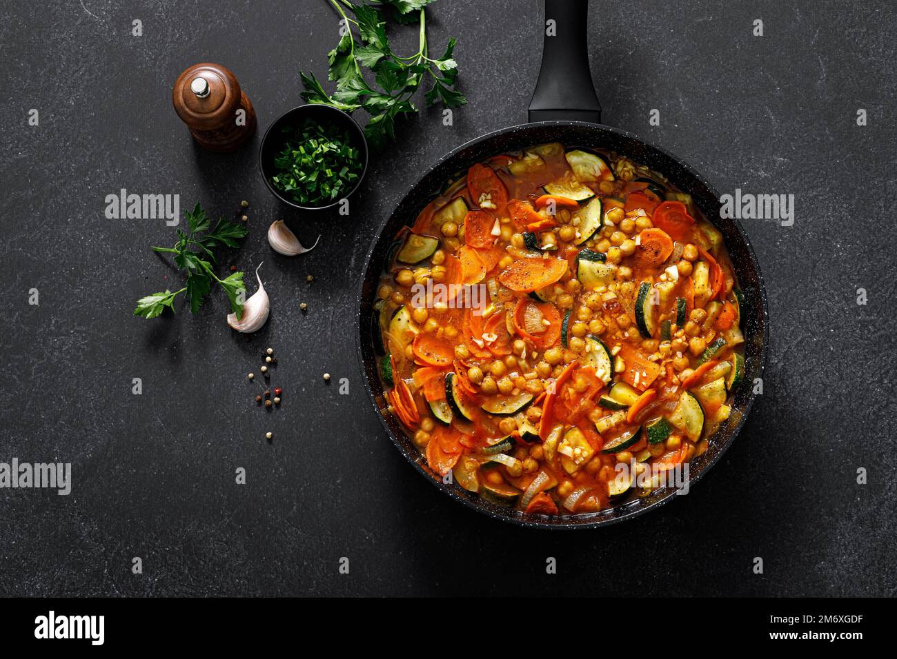 Chickpea and zucchini saute with carrot and garlic. Classic italian side dish. Top view Stock Photo