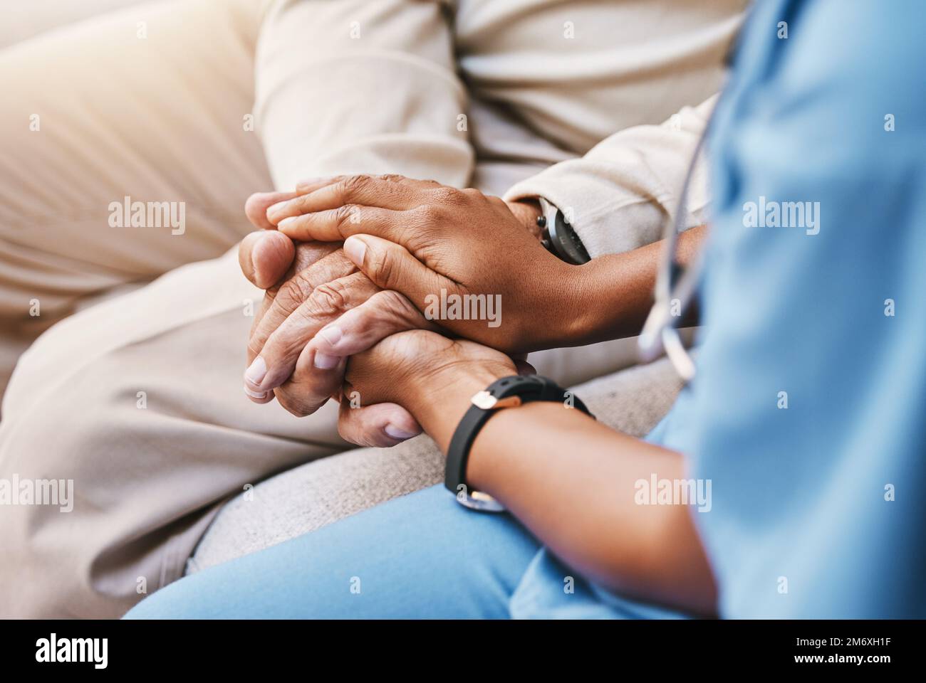 Nurse holding hands with patient in empathy, trust and support of help, advice and healthcare consulting. Kindness, counseling and medical therapy Stock Photo