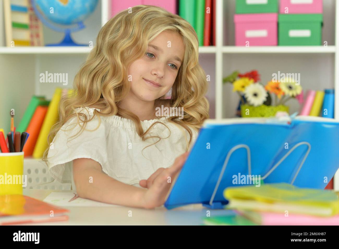 little girl studying at home at the table Stock Photo - Alamy