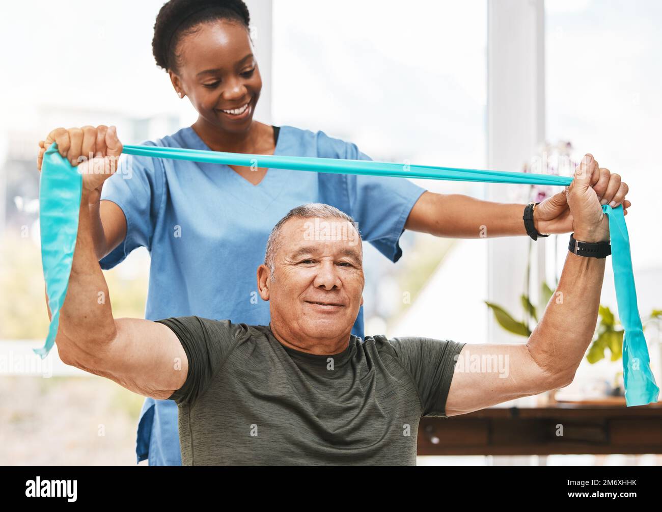 Physiotherapy support, stretching band and nurse with senior man for physical therapy, rehabilitation and healthcare help. Black woman chiropractor or Stock Photo