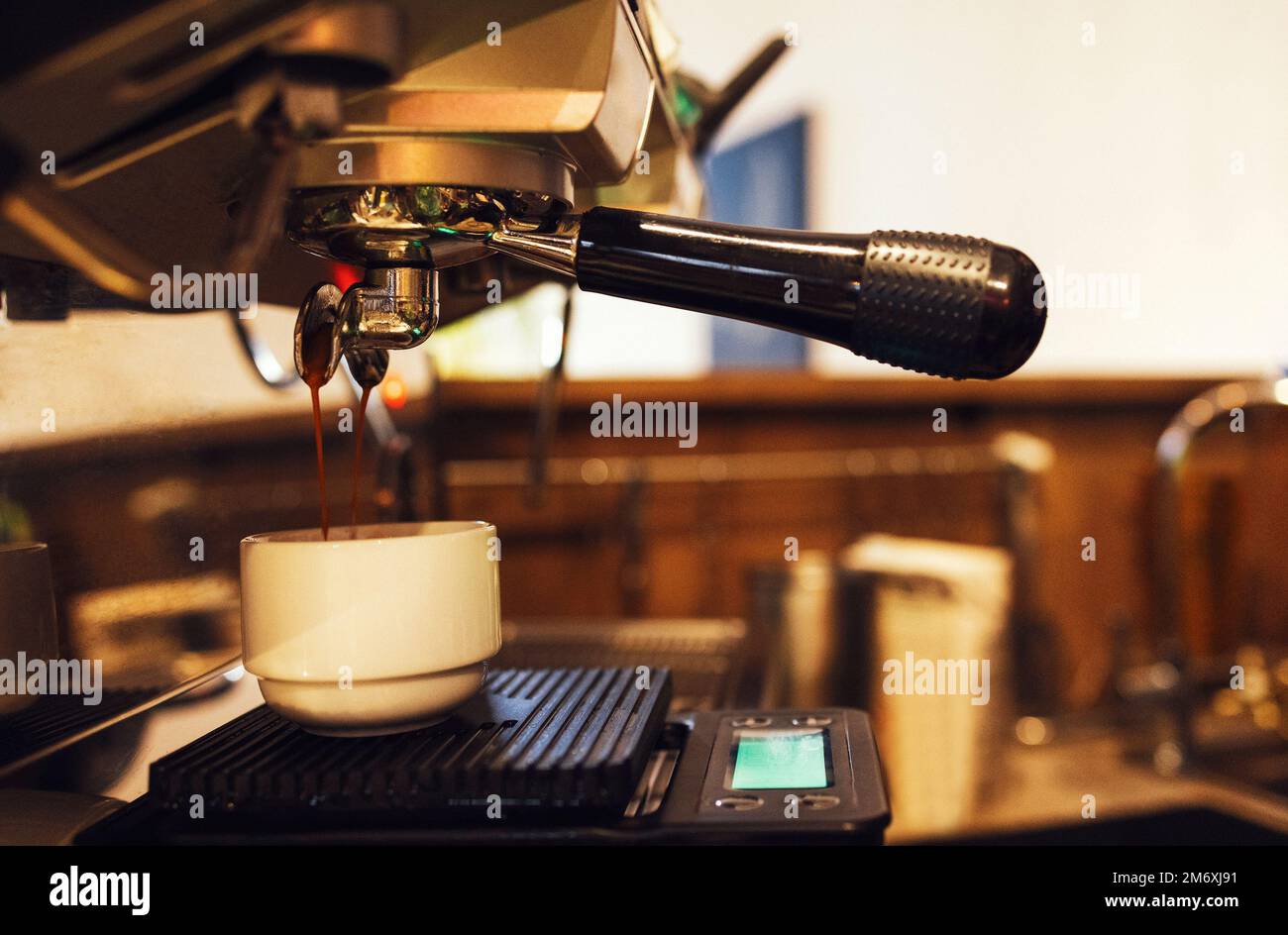 Close up of espresso pouring from coffee machine Stock Photo