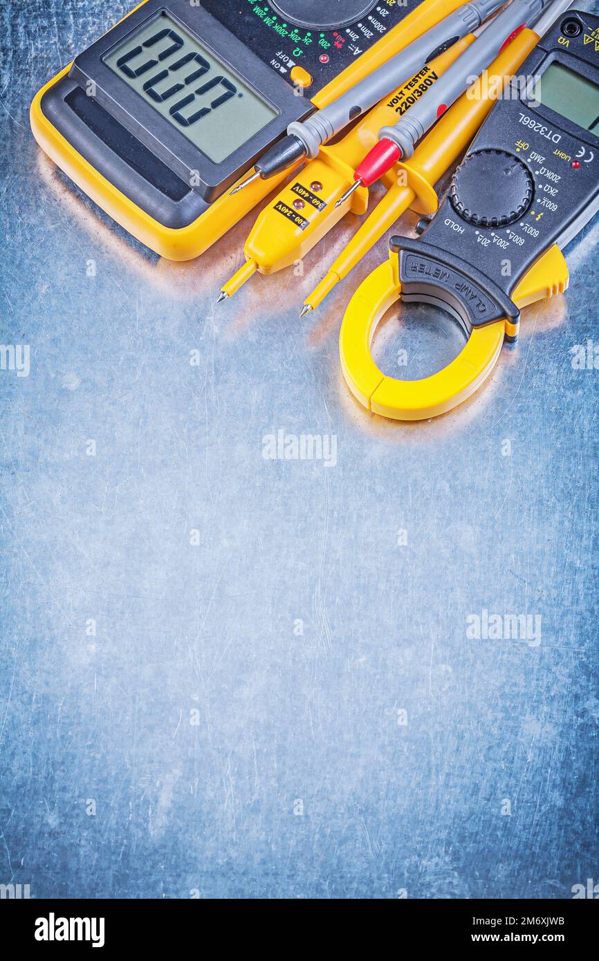 Digital amperemeter electric tester multimeter on metallic background