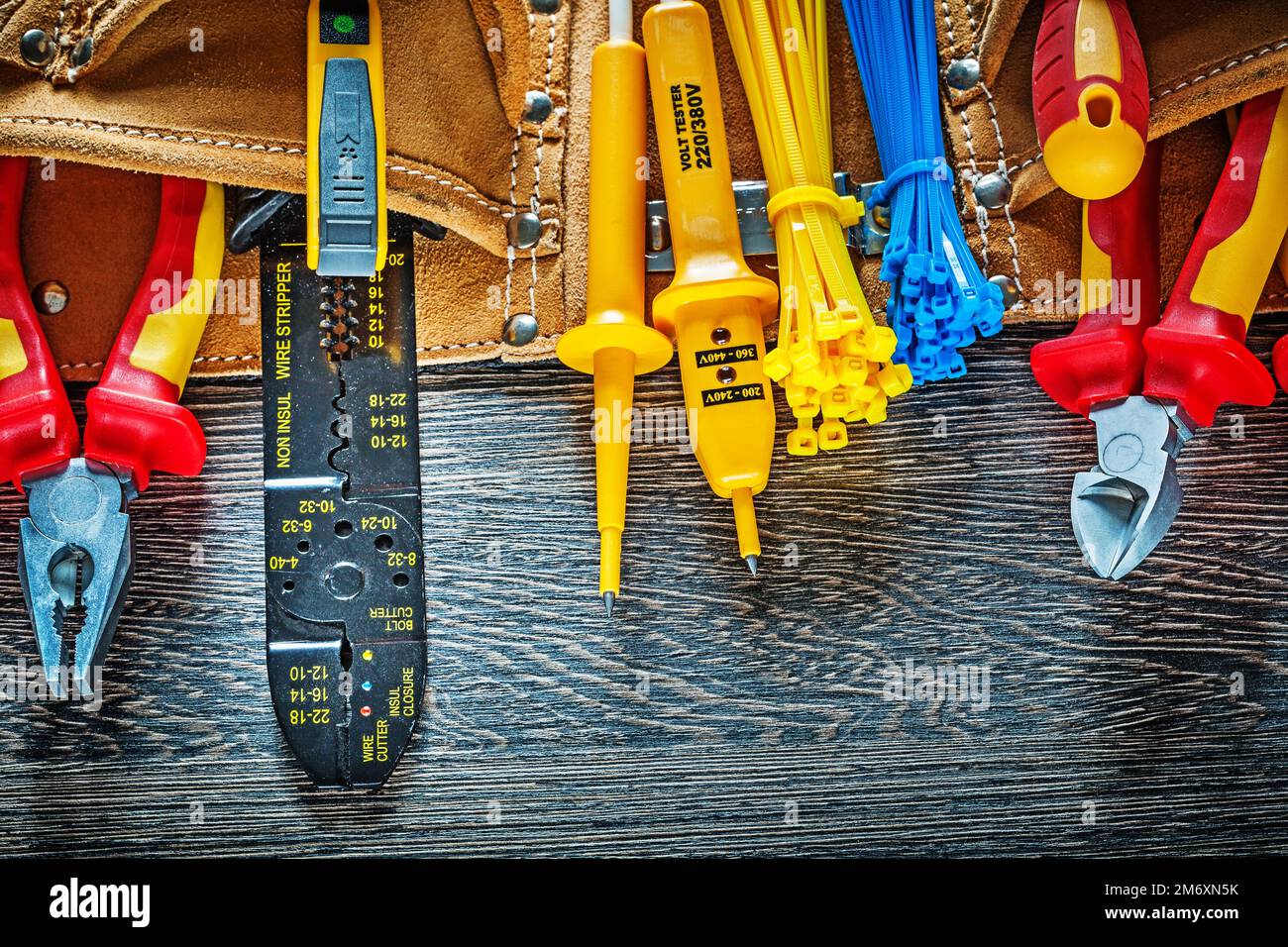 Leather construction belt electrical tools on wood board electricity