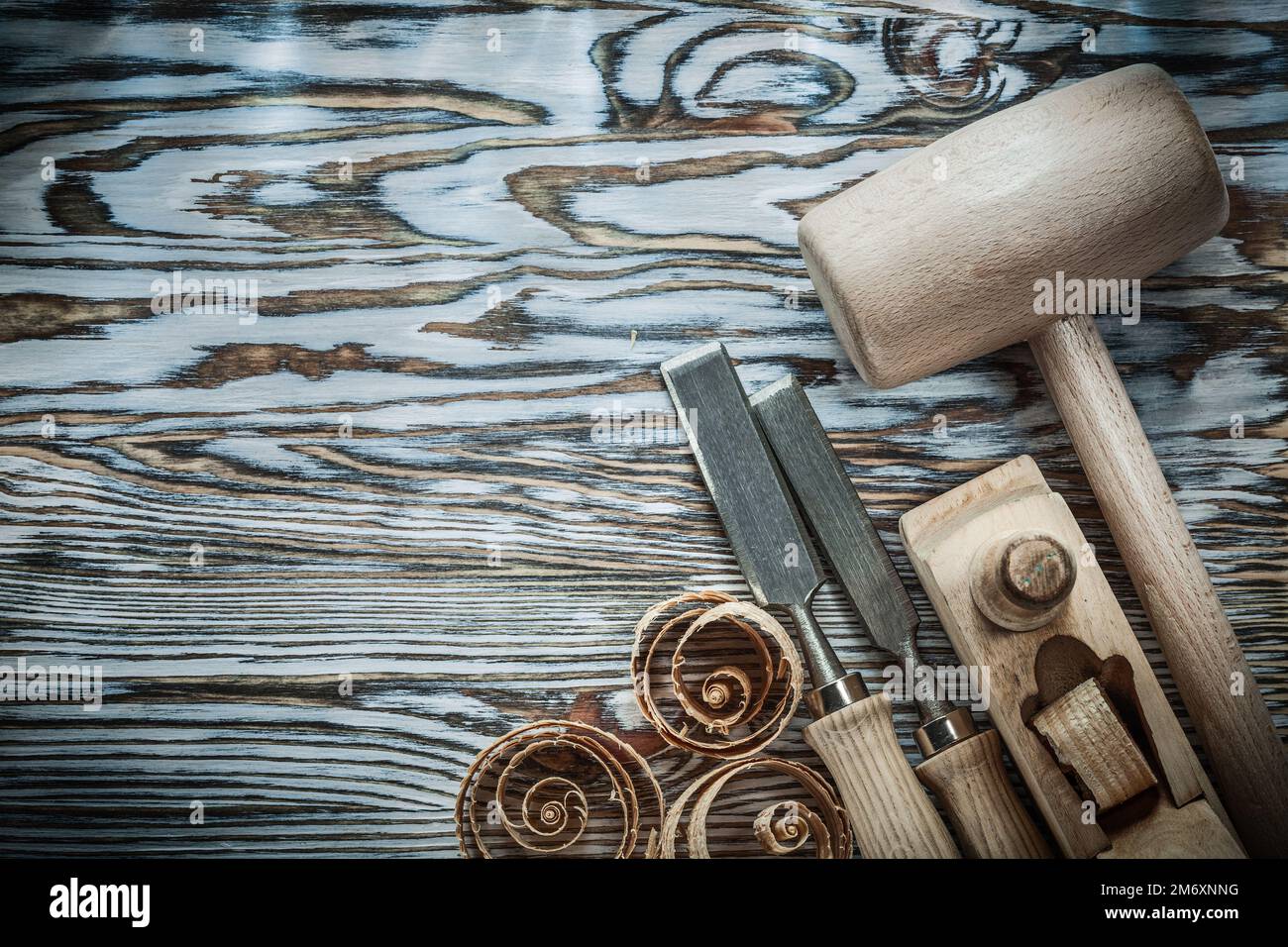 Lump hammer chisels planer curled shavings on wood board. Stock Photo