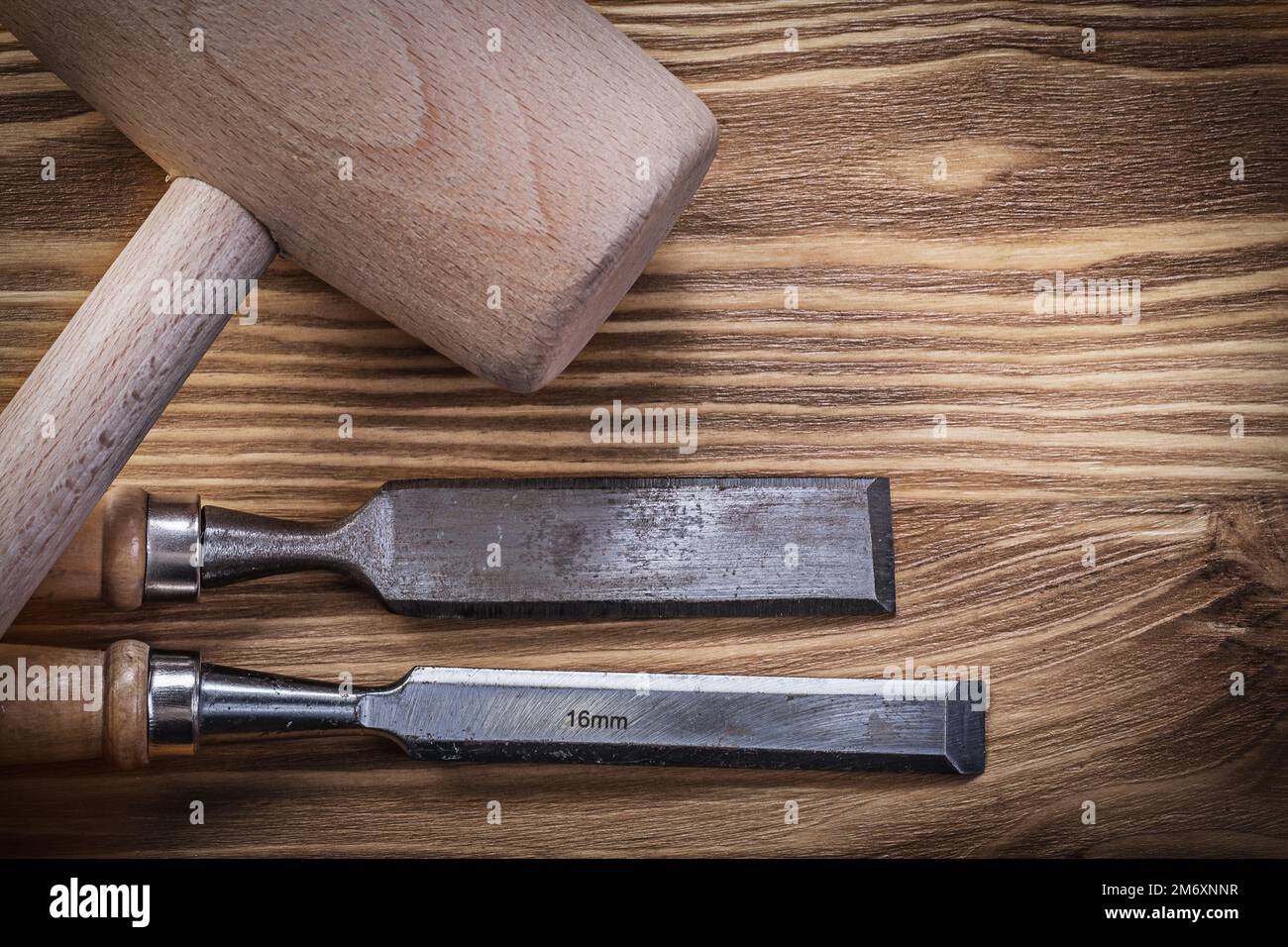 Lump hammer firmer chisels on vintage wooden board construction concept. Stock Photo