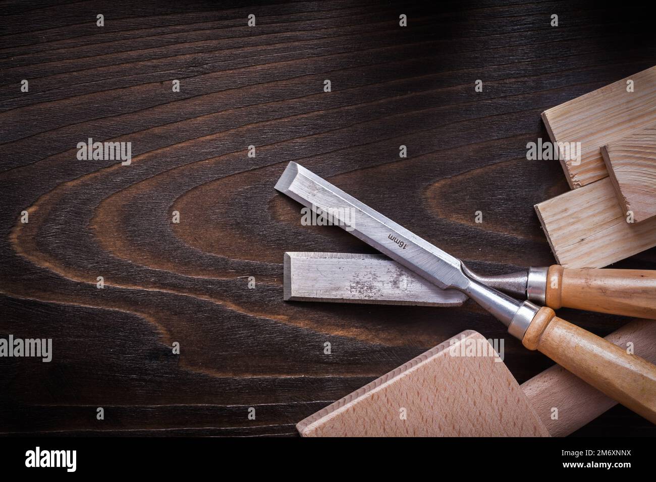 Lump hammer firmer chisels and wooden planks on brown vintage wood board construction concept. Stock Photo