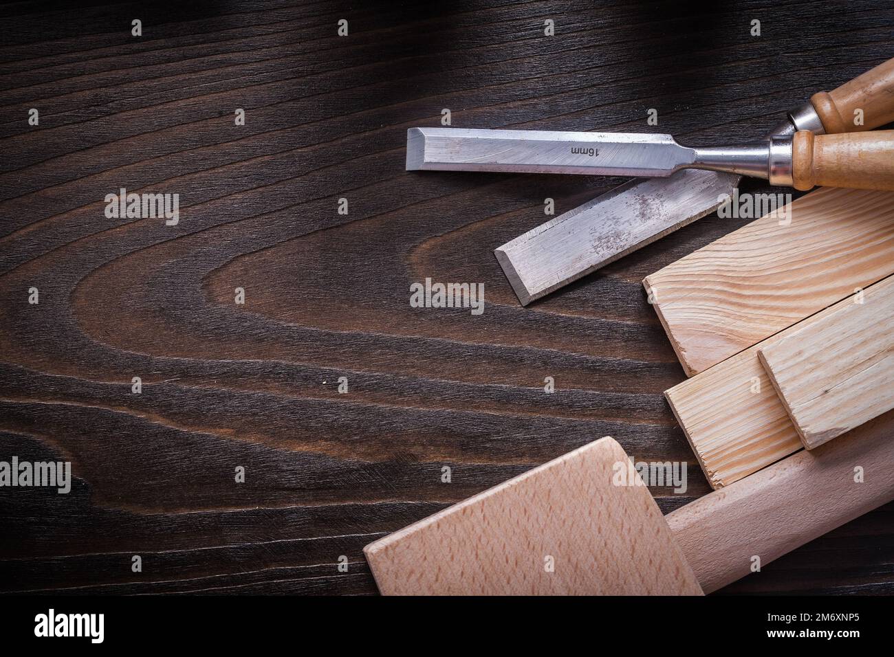 Lump hammer flat chisels and wooden bricks on brown vintage wood board copy space image construction concept. Stock Photo