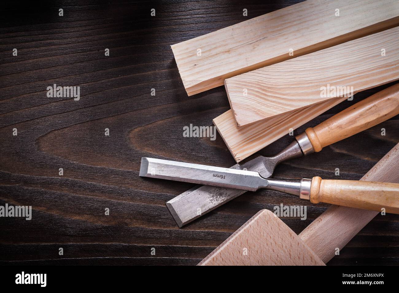 Lump hammer flat chisels and wooden bricks on brown vintage wood board construction concept. Stock Photo