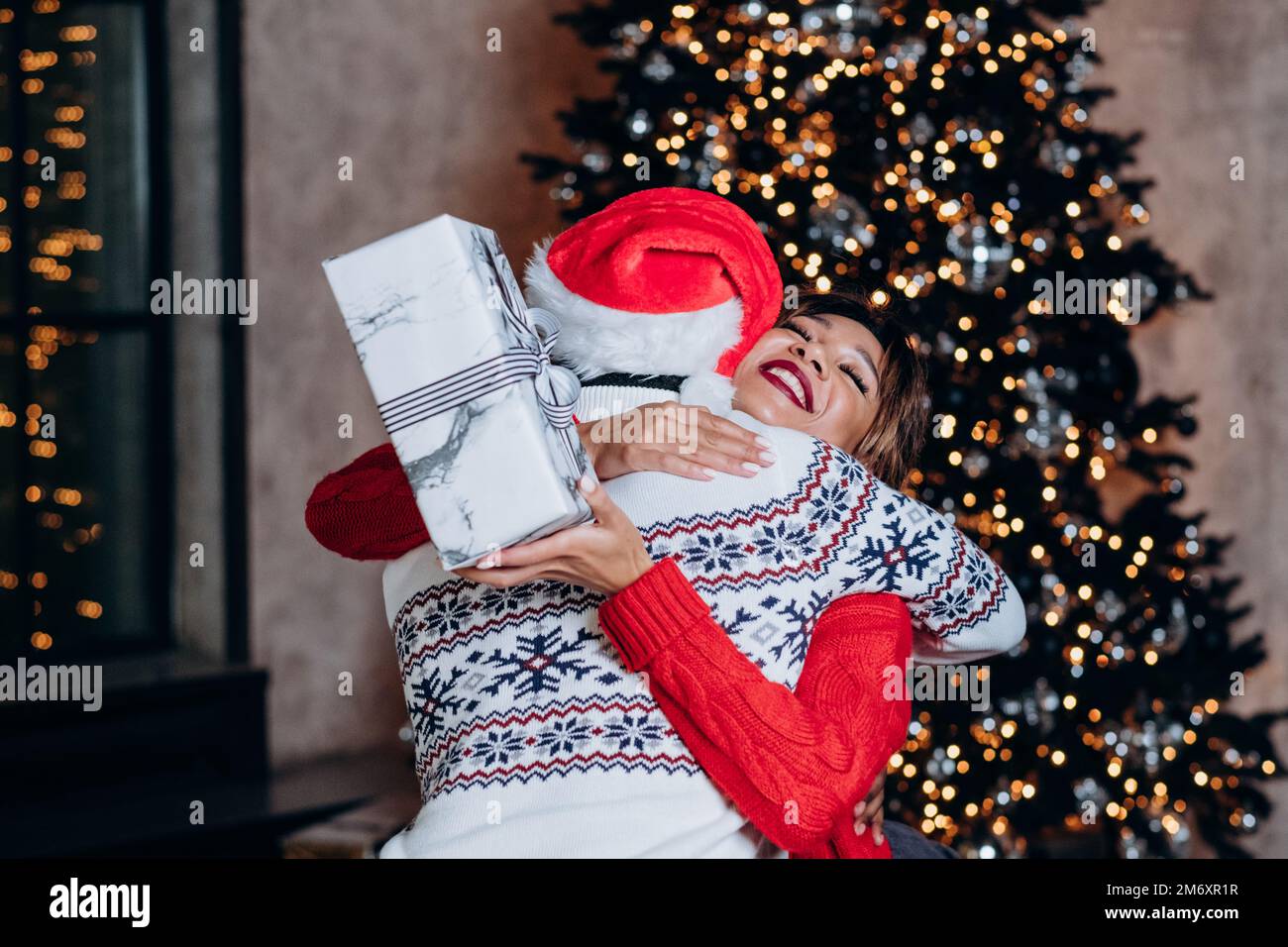 Happy black man hugs woman hi-res stock photography and images - Alamy