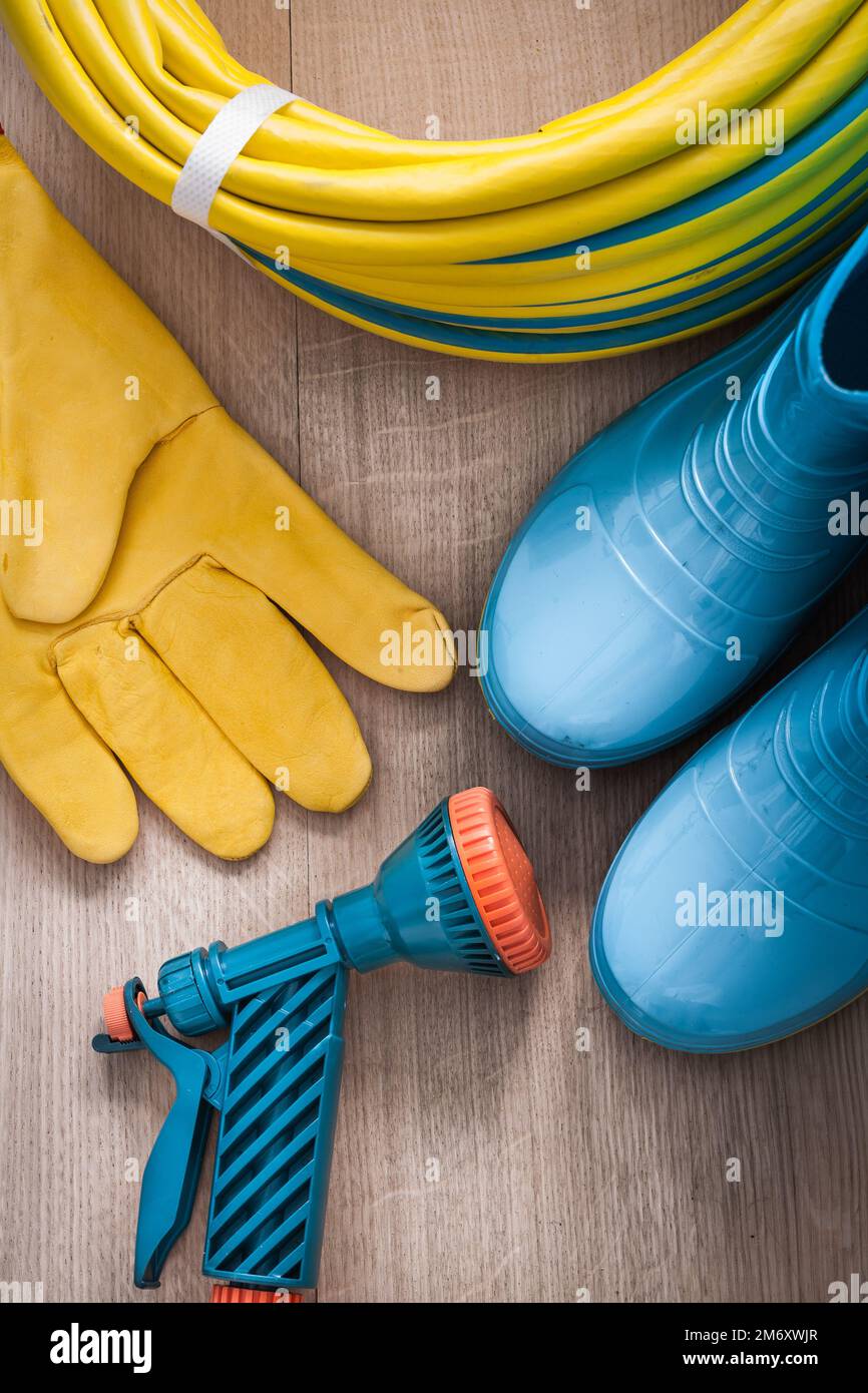 Hand spraying rubber hose with spray nozzle leather safety gloves and