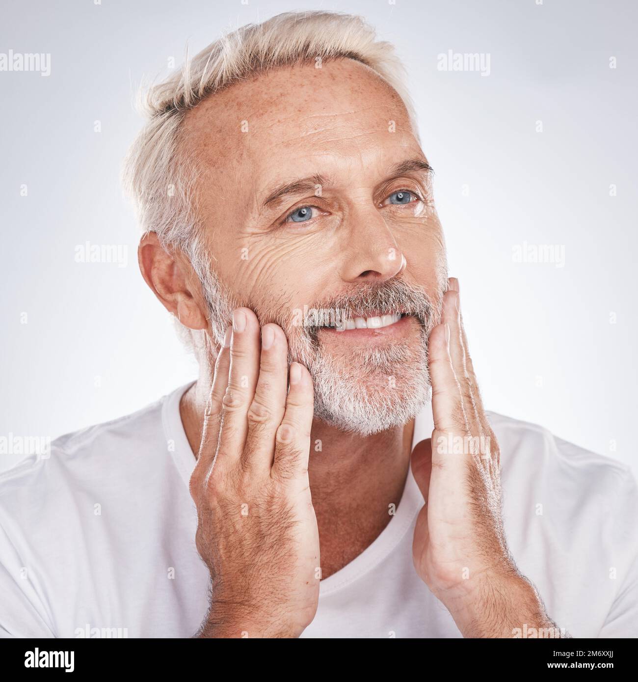 Healthy skincare, mature man and touching face on studio background