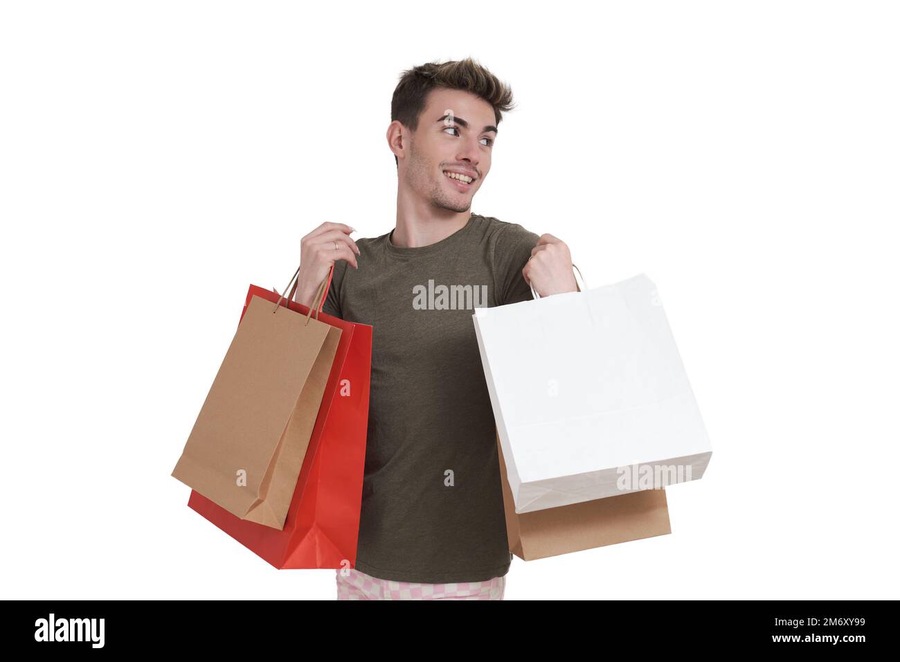 Young caucasian man smiling and holding shopping bags, isolated. Stock Photo