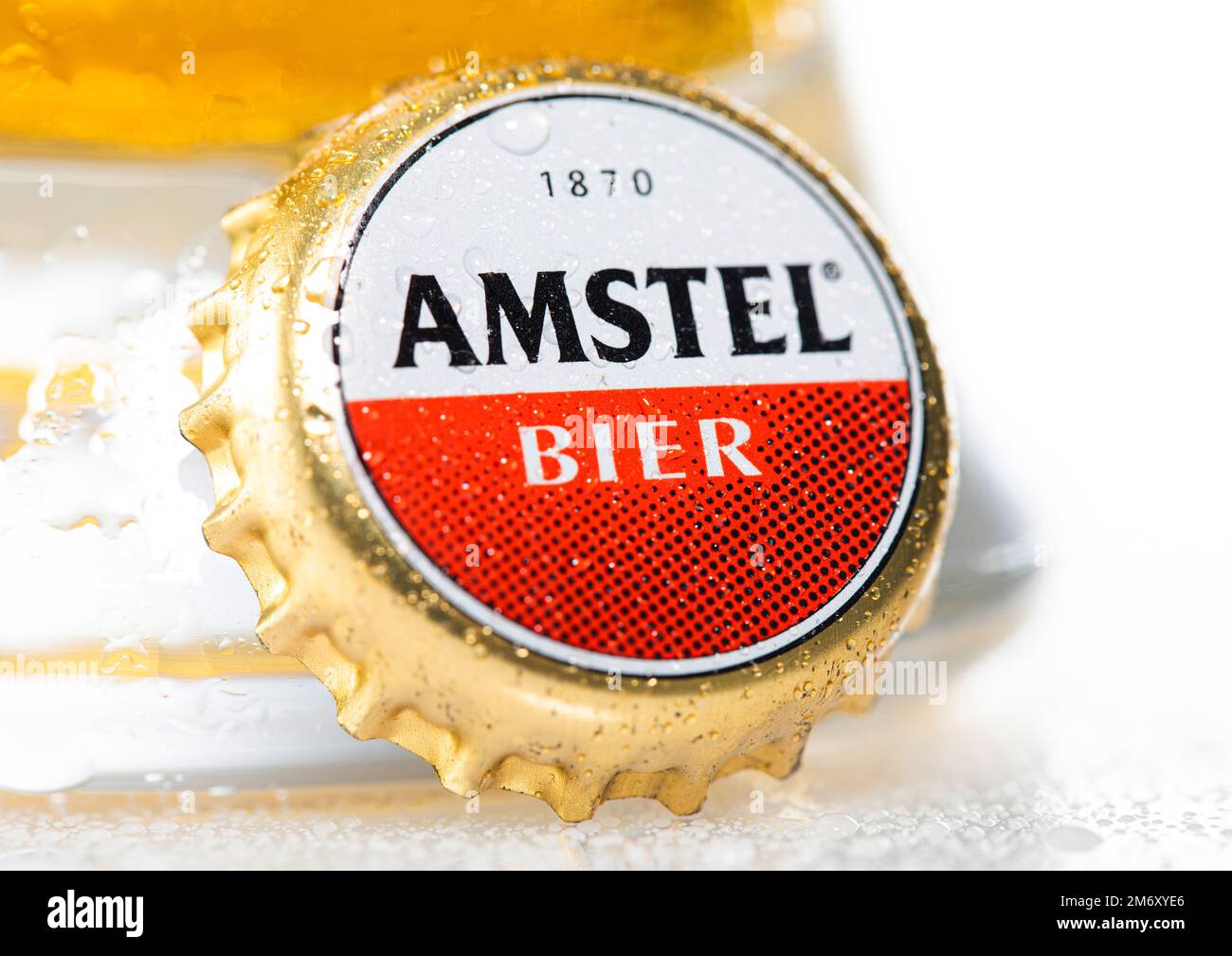 LONDON, UK - DECEMBER 29, 2022: Amstel lager beer bottle cap with dew and cold glass on white. Stock Photo