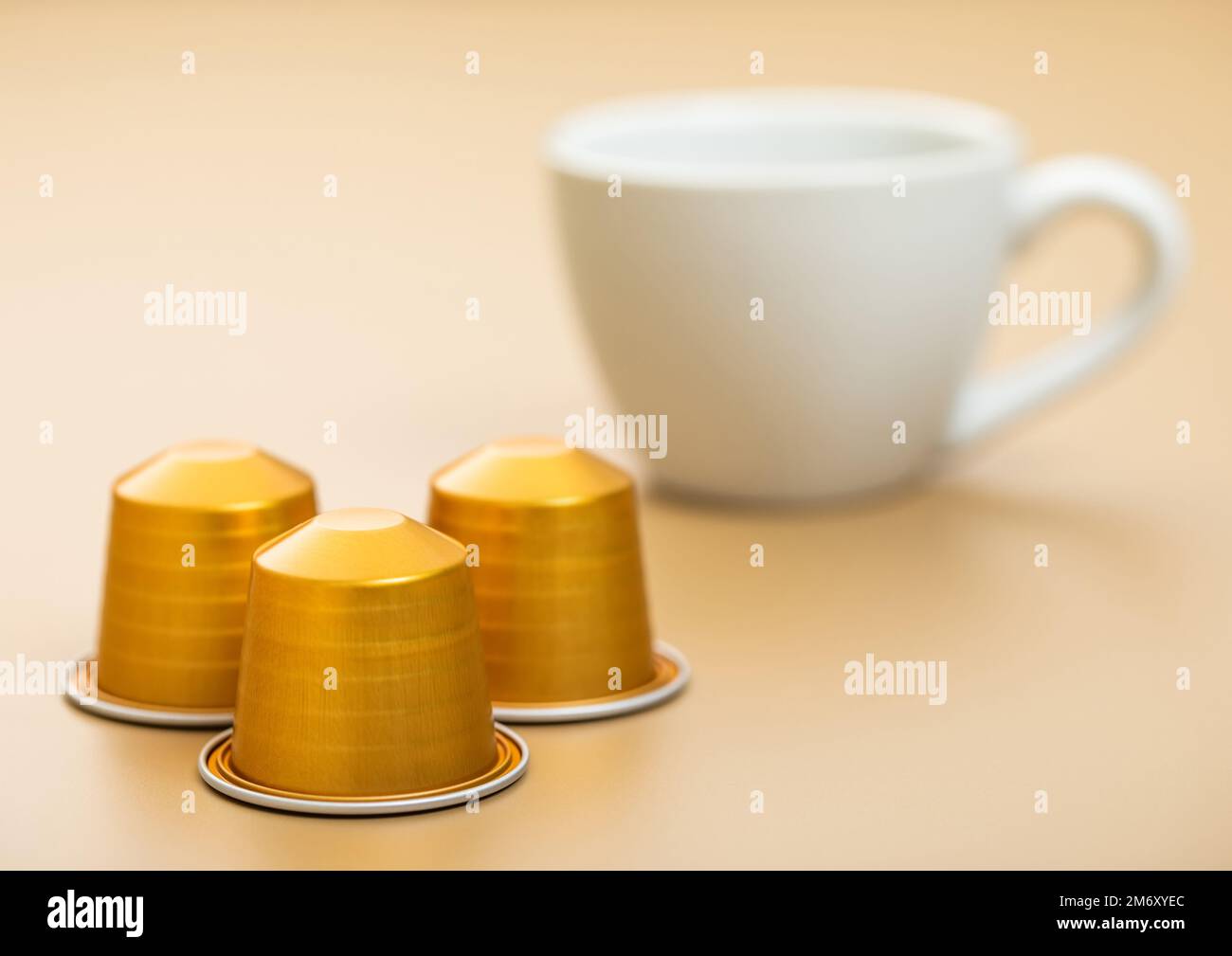 Aluminium coffee capsules pods for coffee machine with white cup on