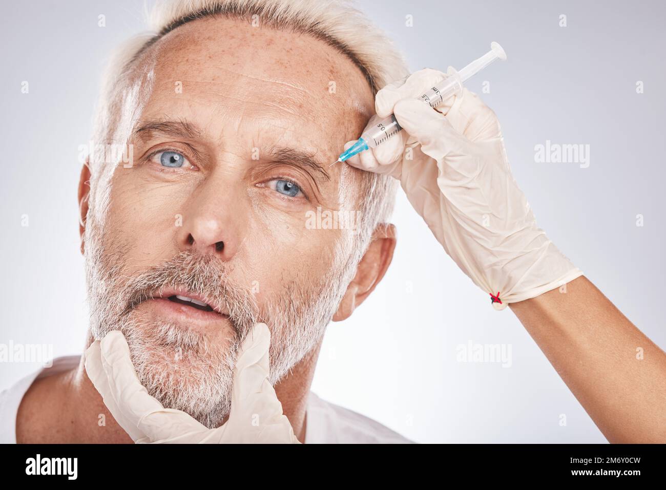 Botox, face and portrait of a senior man doing a cosmetic anti aging treatment in the studio. Plastic cosmetology, filler and elderly guy with Stock Photo