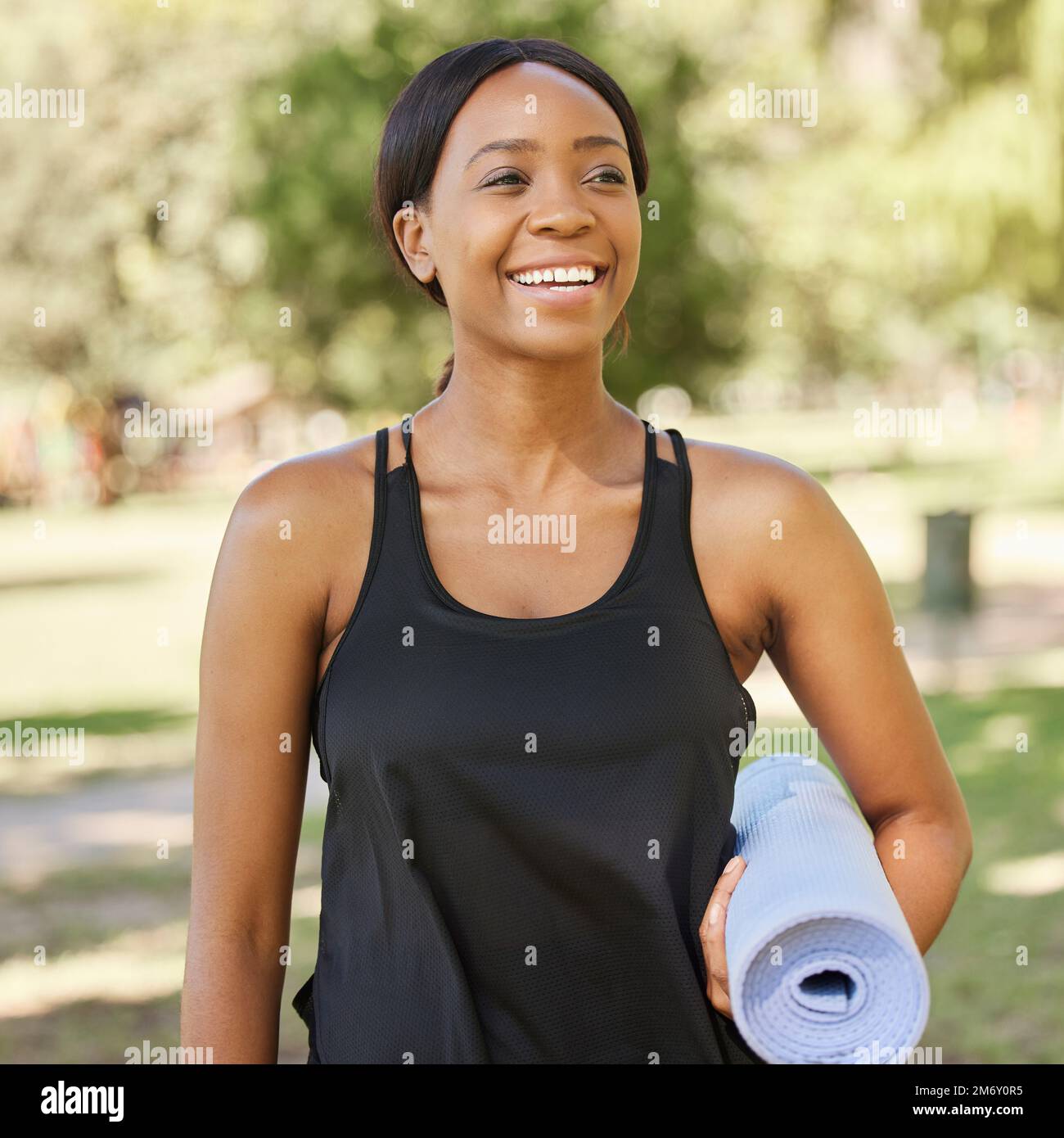 Yoga, exercise mat and mindfulness with a black woman in a park, outdoor for fitness, health or wellness. Mental health, pilates and workout with a Stock Photo