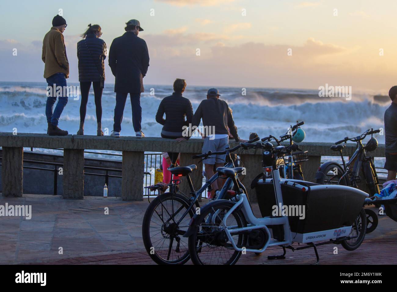 Montecito, California, U.S.A. 6th Jan, 2023. Santa Barbara Country residents flock to Butterfly Beach, in front of the Four Season's Hotel ''” a popular beach where the royals and celebrities are often spotted ''” to see the giant waves brought on by the storm surge and atmospheric river after days of rain ''” a rare occurrence. Much of Montecito was evacuated the previous night due to concerns of mud and landslides. This week marks the five year anniversary of the Montecito Mudslides that followed the Thomas Fire and killed 23 people, so many were on edge, but during this dryer, sunset ho Stock Photo
