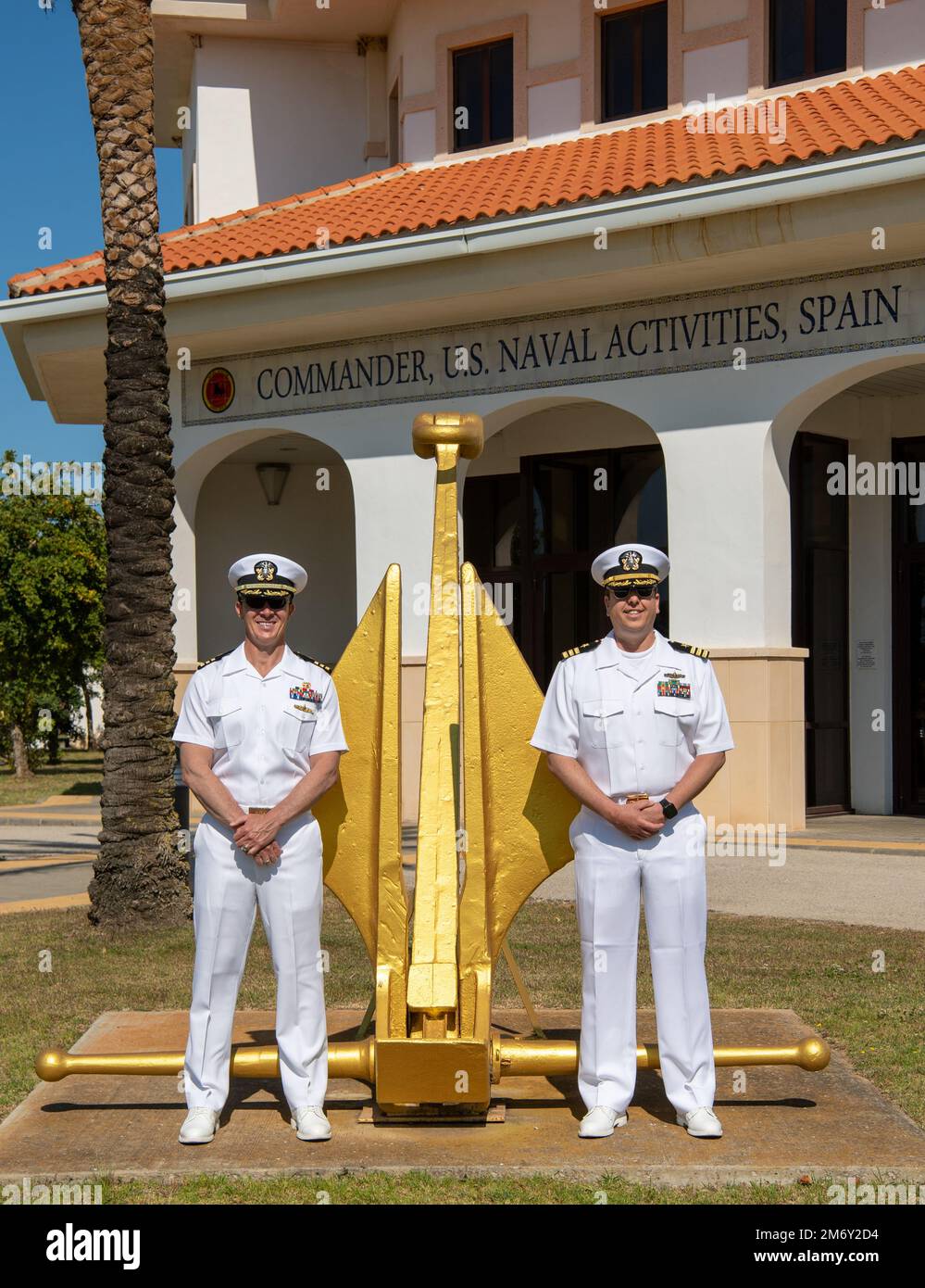 NAVAL STATION ROTA, Spain (May 9, 2022) – Cmdr. David Paz, left, and Cmdr. Mark Krozel, right, pose for a photo in front of the Naval Station Rota, Spain command building. Both depart Rota soon for their naval attaché training and then continue on to their respective countries. Stock Photo