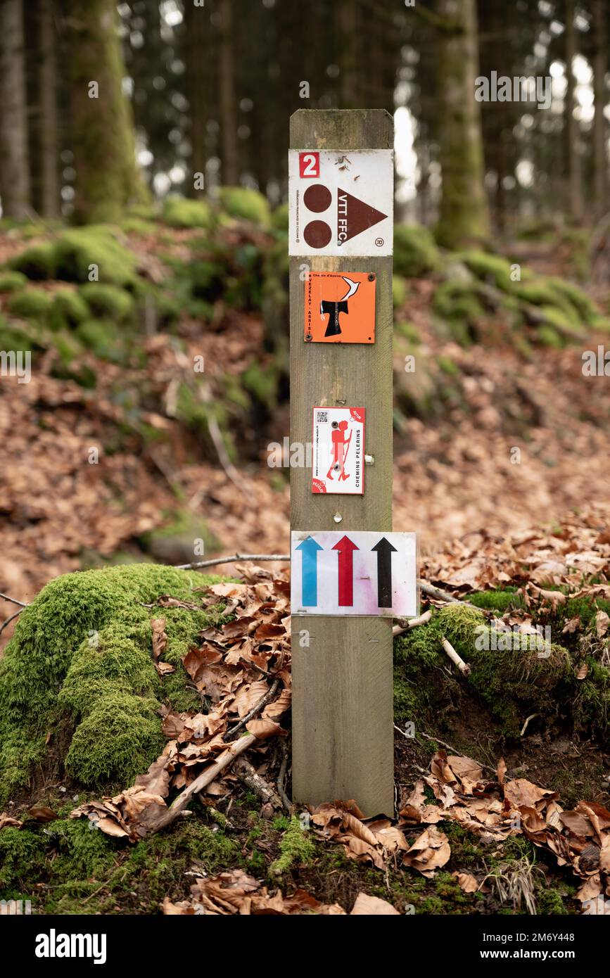 Marking of a long-distance hiking route (white and red). Itineraries trail. Marking on wood. Incication of change of direction. Hiking trail. Marking Stock Photo