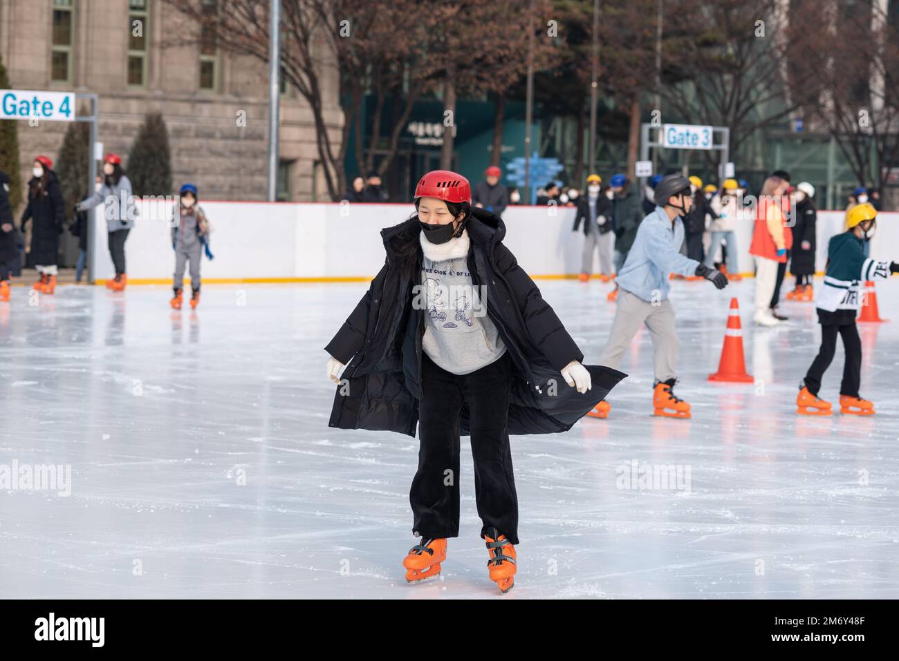 People ice skating on the temporary ice skating ring in front of the