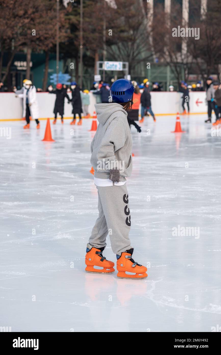 People ice skating on the temporary ice skating ring in front of the