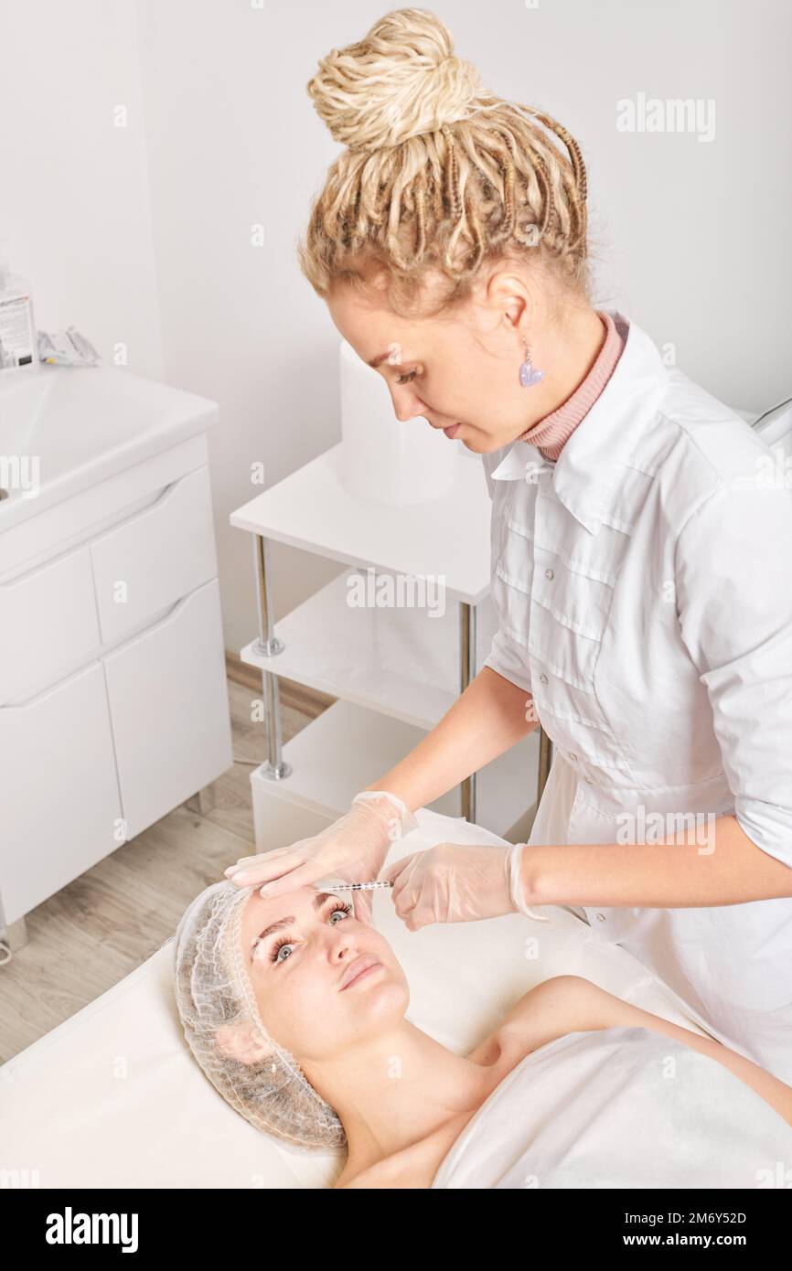 Cosmetologist makes rejuvenation injection in woman face, anti aging ...