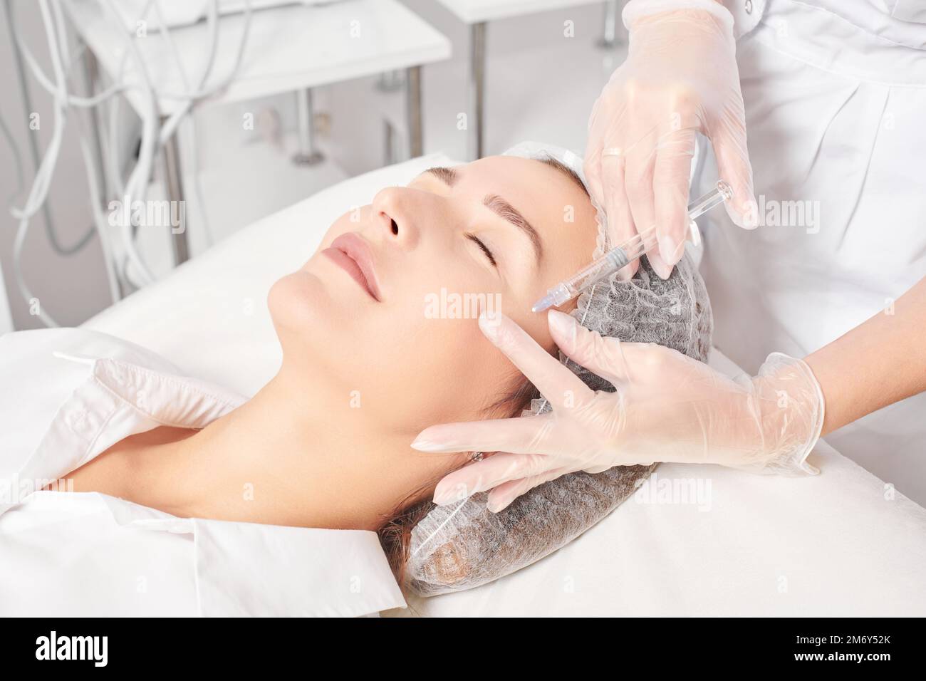 Cosmetologist makes rejuvenation injection in woman face skin, anti ...