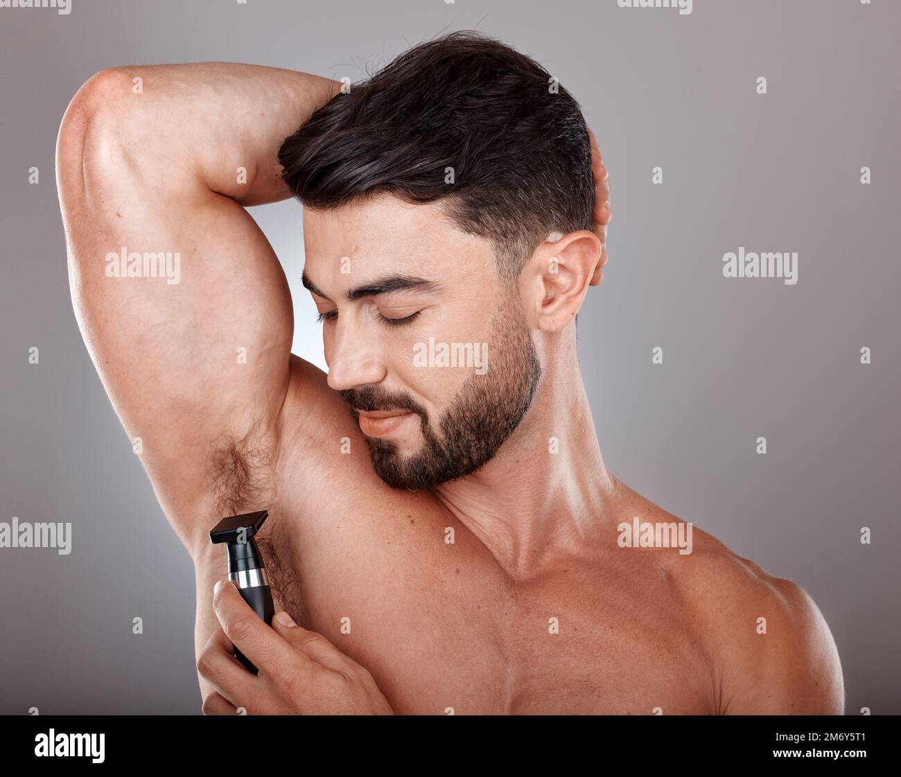 Charming Sexy Sports Young Man With Dark Hair Demonstrates His Smooth Armpit,  In The Other Hand Holds A Wooden Comb And Looks Straight. Men's Problem Of Hair  Loss, Dandruff. Male Pattern Baldness.