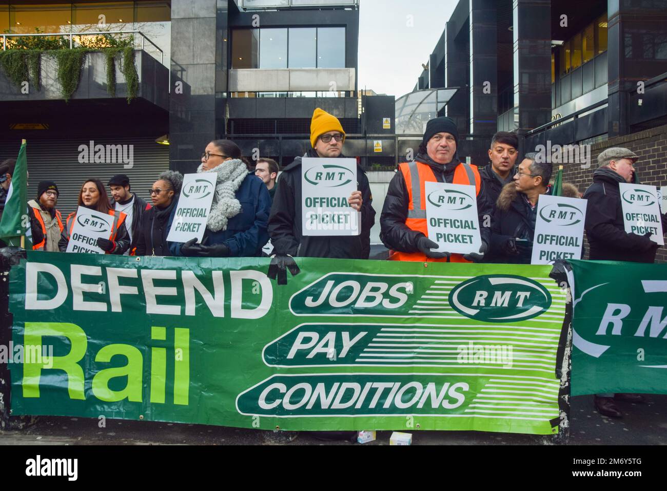 London, UK. 6th January 2023. Rail workers stand at the RMT (Rail