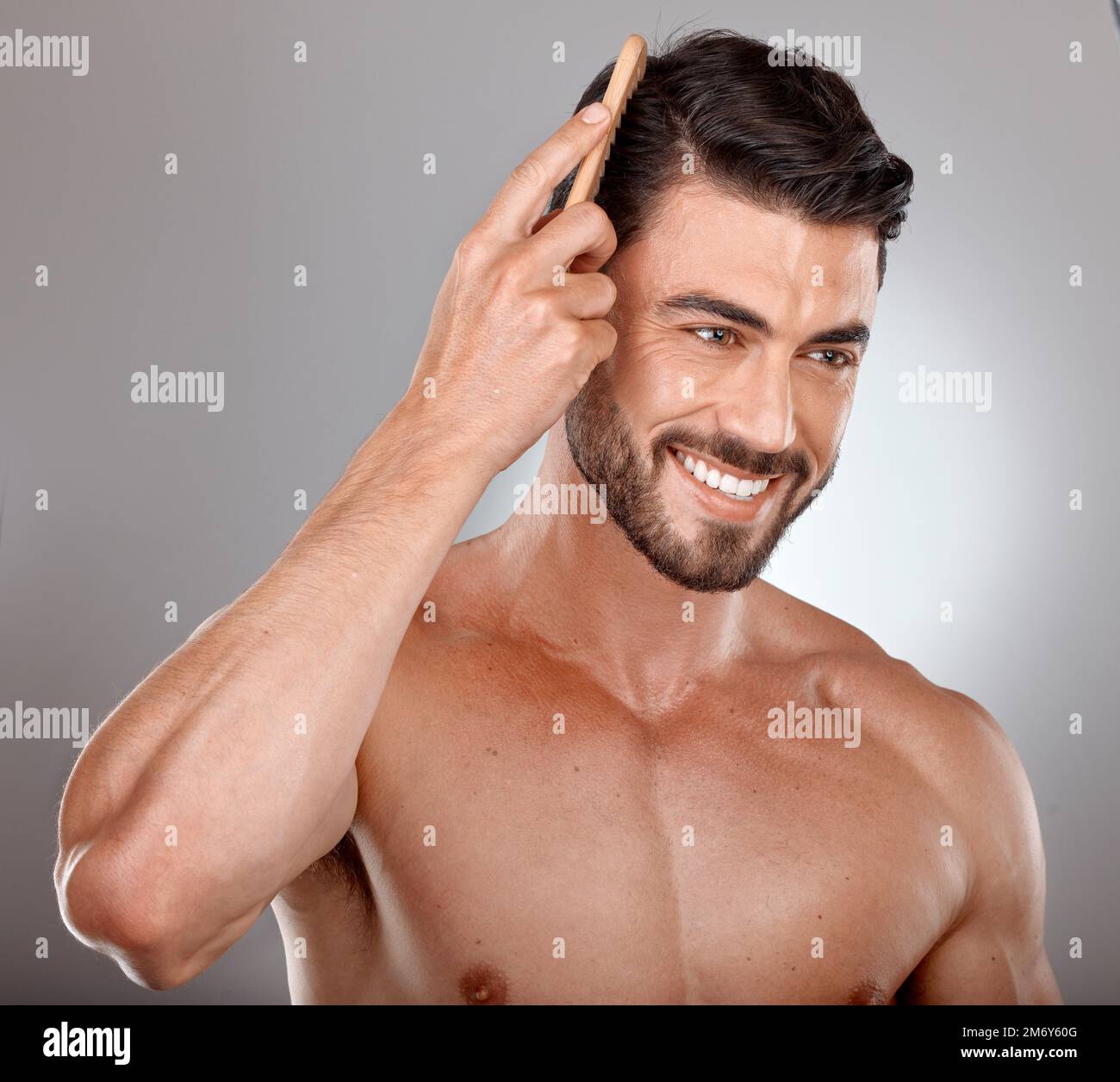 Comb, beauty or man brushing hair in grooming advertising or marketing salon hair care products. Happy, studio background or healthy male model smiles Stock Photo