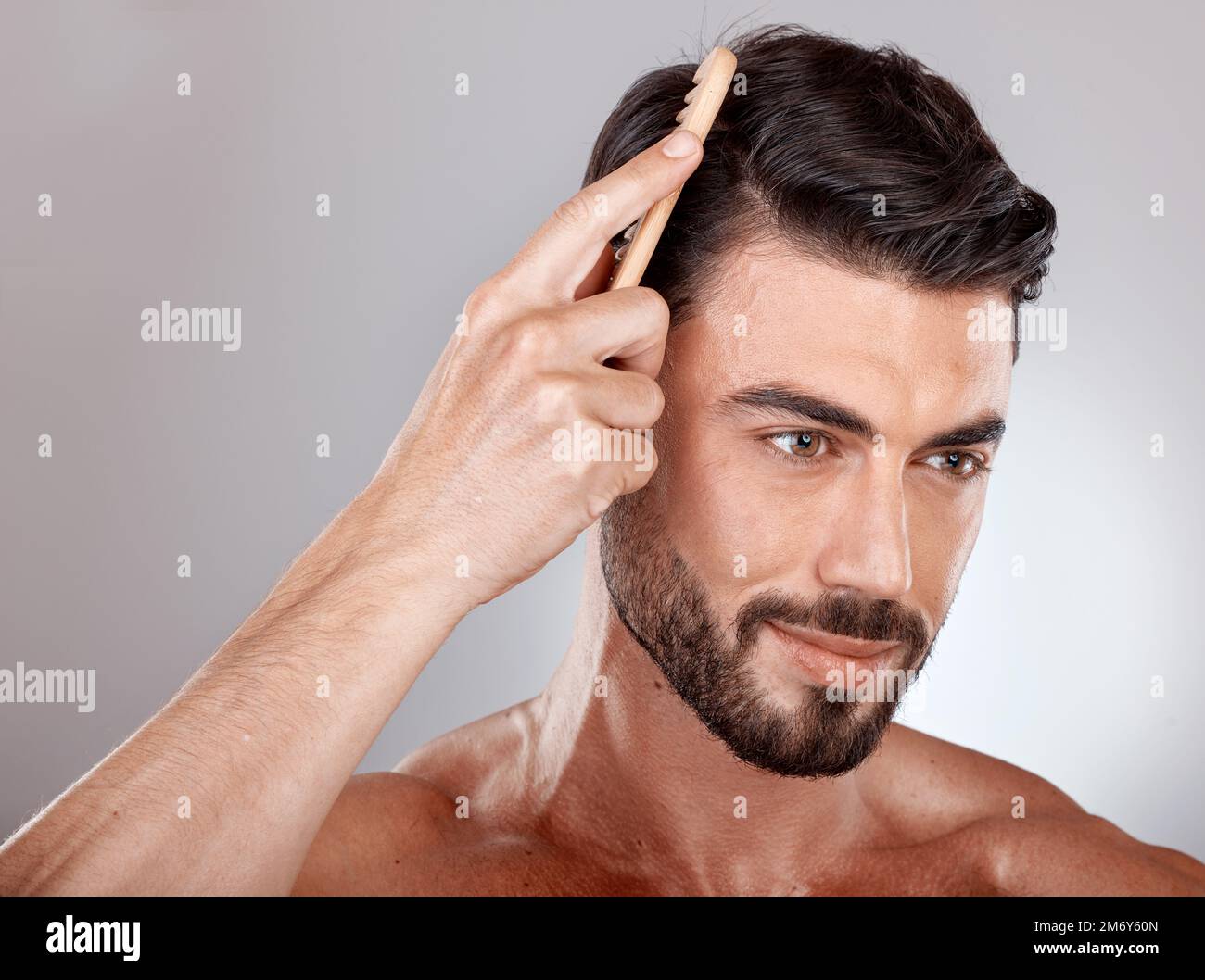 Comb, beauty or man brushing hair for grooming advertising or marketing salon hair care products. Thinking, studio background or healthy male model Stock Photo