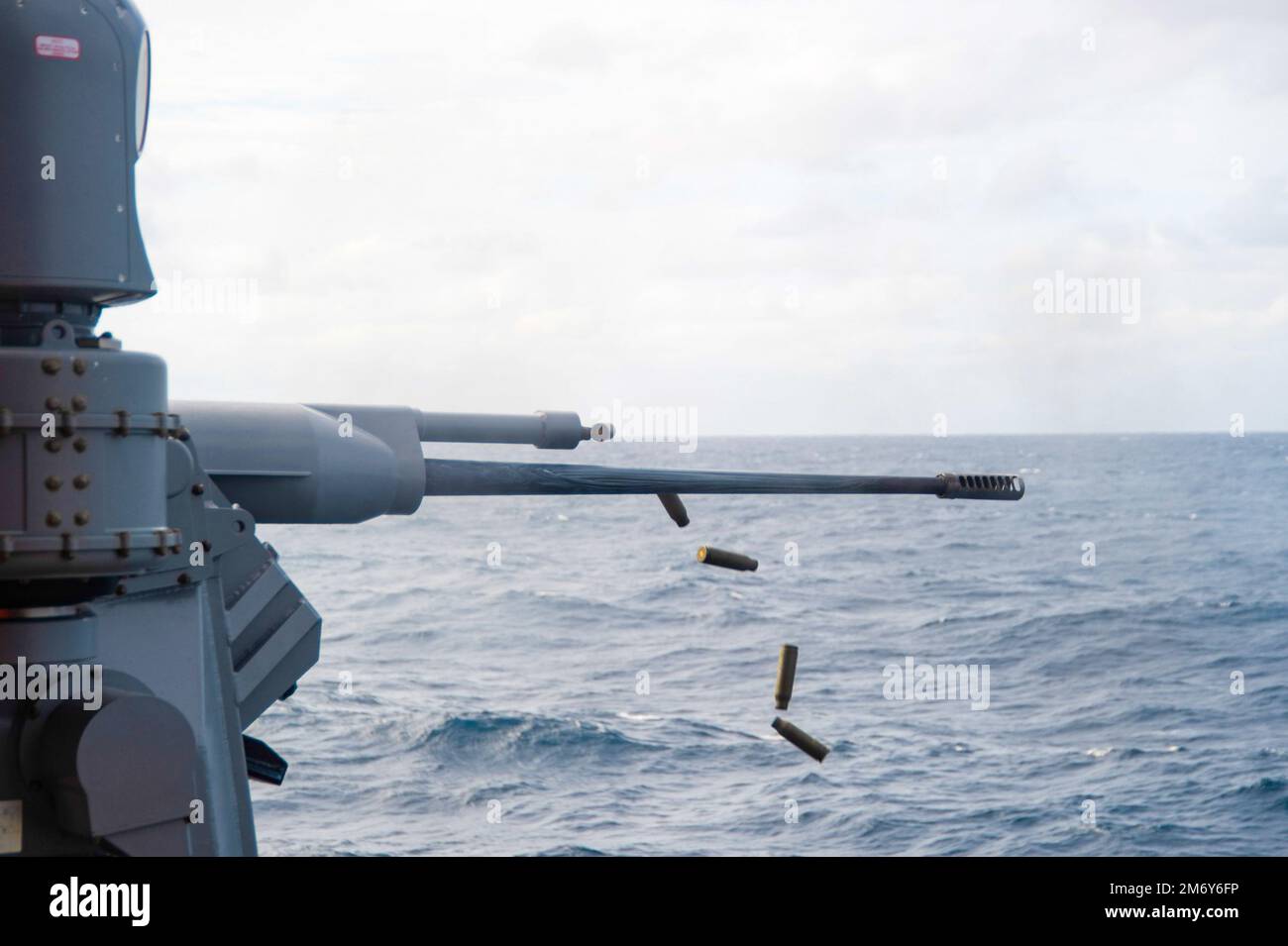 20510-N-YX844-2074 PACIFIC OCEAN (May 10, 2022) A MK 38 Machine Gun System is fired on the fantail of the U.S. Navy’s only forward-deployed aircraft carrier USS Ronald Reagan (CVN 76), during a live fire exercise. The MK 38 is a remote controlled weapon system that fires 25 mm rounds. Ronald Reagan, the flagship of Carrier Strike Group 5, provides a combat-ready force that protects and defends the United States, and supports alliances, partnerships and collective maritime interests in the Indo-Pacific region. Stock Photo