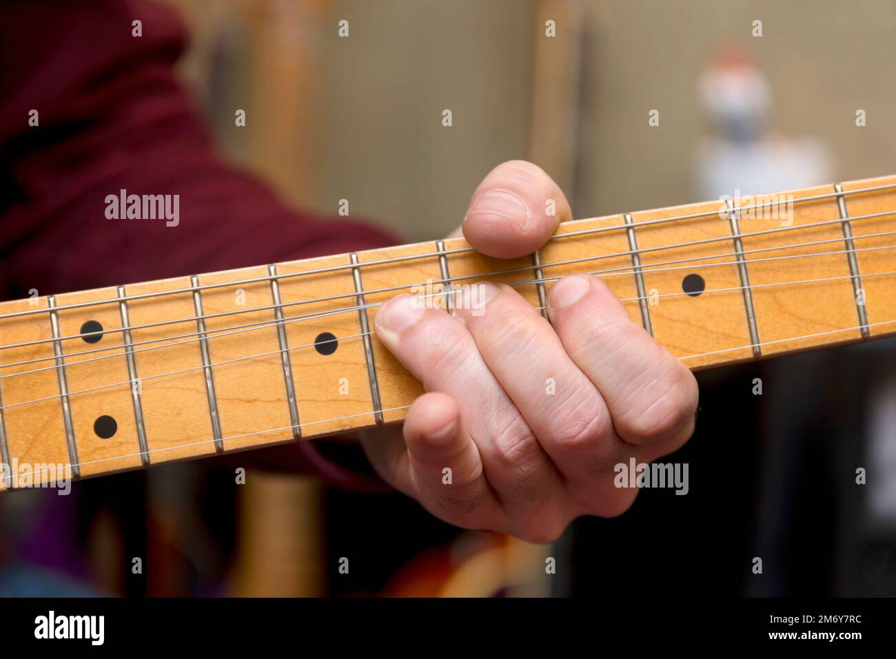 Close Up Shot Of A Male Hand Playing Electric Guitar, Bending Strings Stock Photo