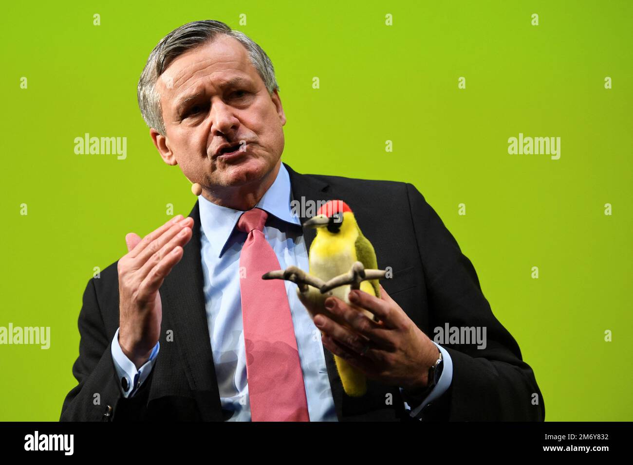 The chairman of the FDP parliamentary group in Baden-Wuerttemberg Hans-Ulrich Ruelke holds a padded green woodpecker as he speaks during the traditional FDP Epiphany meeting in Stuttgart, Germany, January 6, 2023. REUTERS/Andreas Gebert Stock Photo