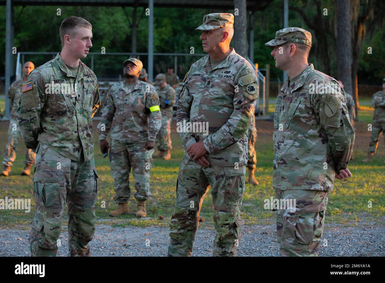 U.S. Army Command Sgt. Major Jeff Logan, the Georgia Army National Guard Command Sgt. Major, center, speaks to Spc. Keenan Baxter, representing the Georgia Army National Guard, left, during the Best Warrior Competition on Camp Blanding, Fla., May 10, 2022. The Regional Best Warrior Competition highlights the lethality, readiness and capabilities of Army National Guardsman throughout the southeastern region. Stock Photo