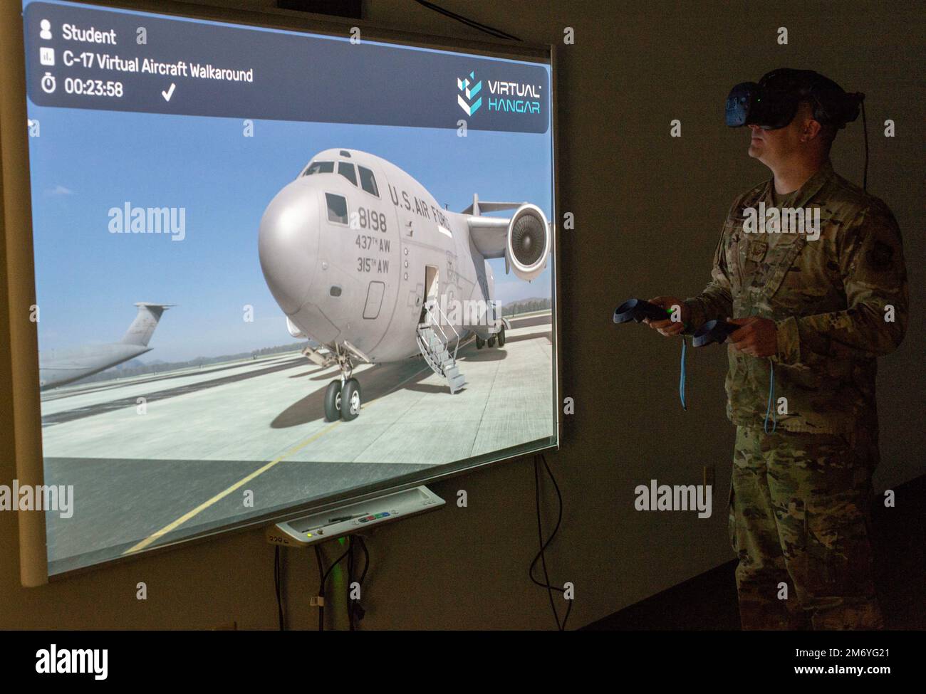 Staff Sgt. James Hart, 436th Aerial Port Squadron fleet services supervisor, walks around a C-17 Globemaster III using virtual reality goggles during a multi-capable Airmen training class at Dover Air Force Base, Delaware, March 29, 2022. Hart and other MCA students used VR goggles to familiarize themselves with C-17 and C-5M Super Galaxy aircraft by performing a virtual walkaround. Stock Photo