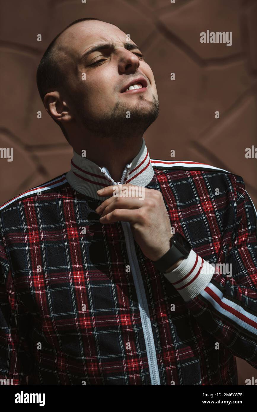 male portrait; emotions of a guy in a suit; the guy in the shirt is standing Stock Photo