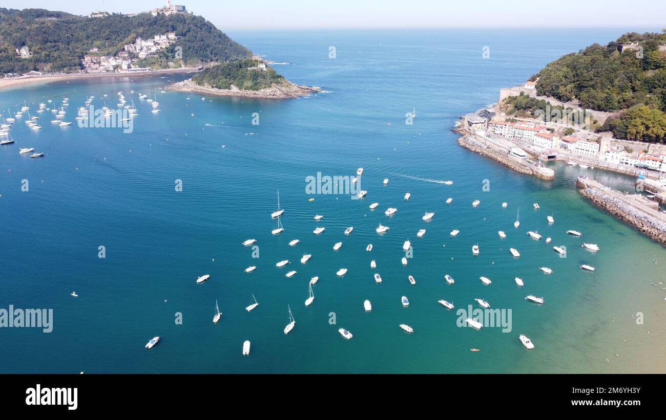 San Sebastian Bay in Spain & Biarritz France aerial footage taken from a drone, perfect summer weather clear blue skies with warm sea water, Stock Photo