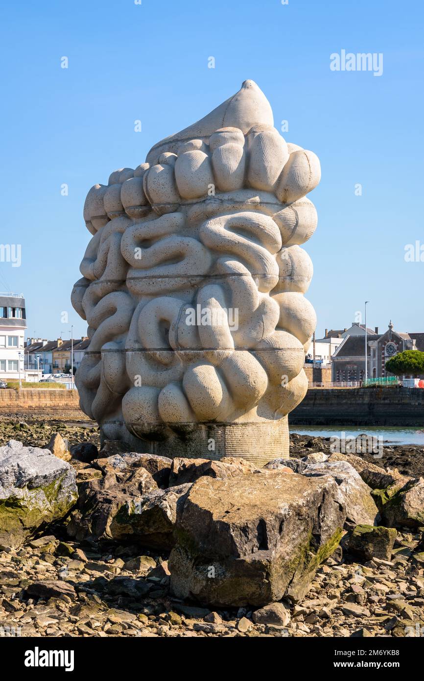 A monumental concrete sculpture representing a human digestive system
