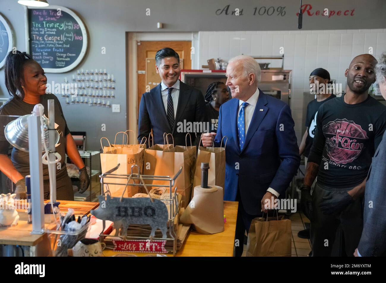 Walnut Hills, United States of America. 04 January, 2023. U.S President Joe Biden, center, stops at Just Q'in BBQ restaurant with Cincinnati Mayor Aftab Pureval, 2nd left, following an infrastructure event at the Brent Spence Bridge, January 4, 2023 in Walnut Hills, Ohio. Credit: Adam Schultz/White House Photo/Alamy Live News Stock Photo