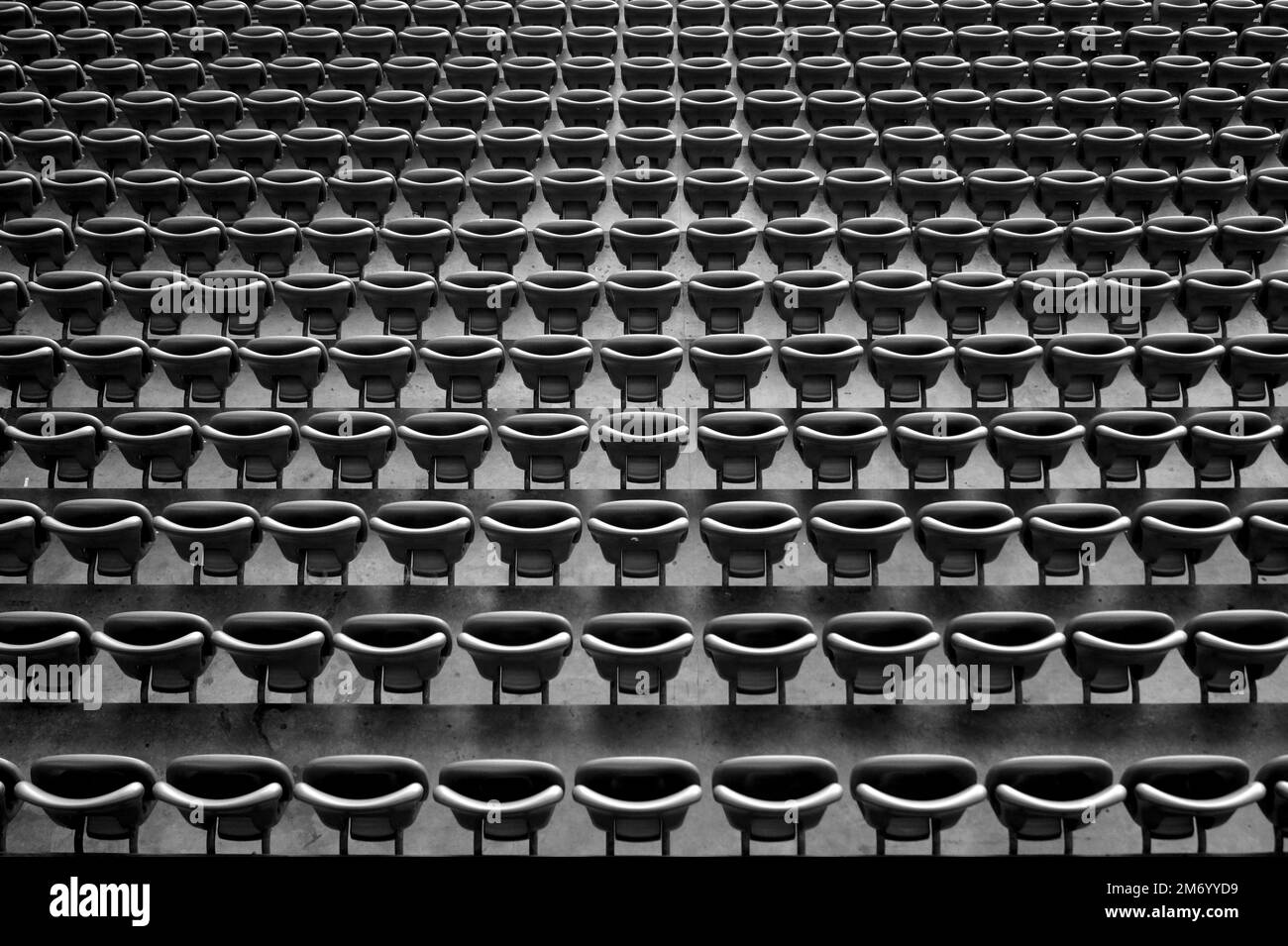 An aerial grayscale of theater seats in an empty stadium, top view of chairs Stock Photo