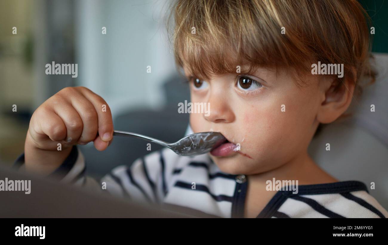 Toddler 2 year old baby eating yogurt2 Stock Photo - Alamy